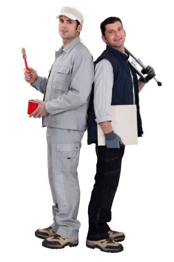 Tradesmen standing back to back clipart