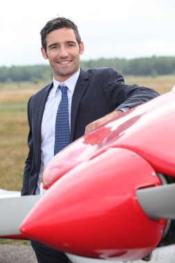 Pilot next to plane clipart