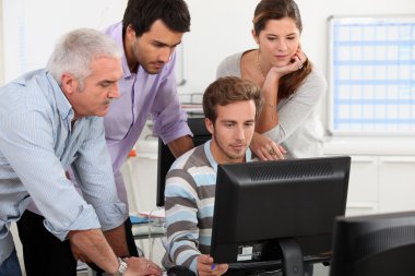 Colleagues looking at computer clipart
