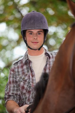 Young man horse riding clipart