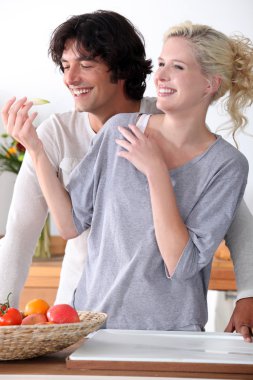 Couple laughing in the kitchen clipart