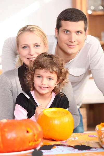 Little girl with parents preparing pumpkin for Halloween — Stock Photo, Image
