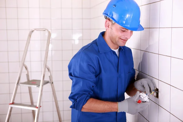 Electrician fitting a light switch — Stock Photo, Image