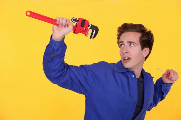Man with a wrench and screwdriver — Stock Photo, Image