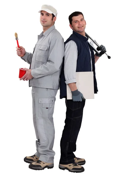 Tradesmen standing back to back — Stock Photo, Image