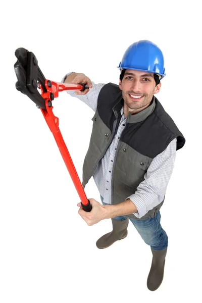Ein männlicher Bauarbeiter mit einer Zange. — Stockfoto