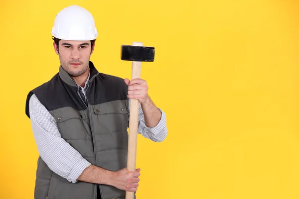A construction worker with a sledgehammer. — Stock Photo, Image