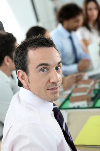 Man looking at the camera during a work meeting discussing a new housing es — Stock Photo, Image