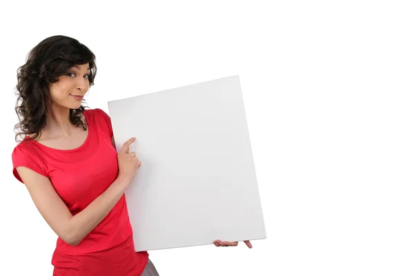 Woman pointing to a blank sign — Stock Photo, Image
