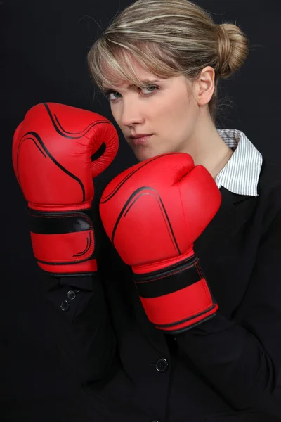Female office worker wearing boxing gloves — Stock Photo, Image