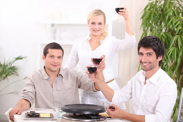Friends enjoying a raclette — Stock Photo, Image