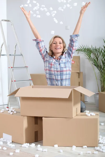 Frau packt freudig Kartons aus — Stockfoto