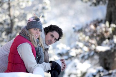 Couple taking a romantic walk in the snow clipart