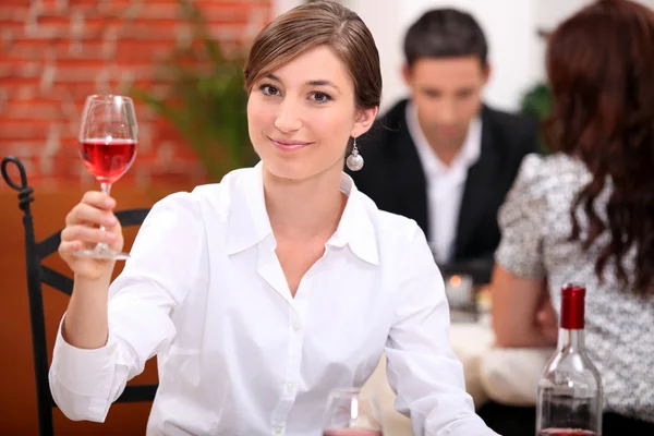 Mujer joven apreciando una copa de vino rosa — Foto de Stock