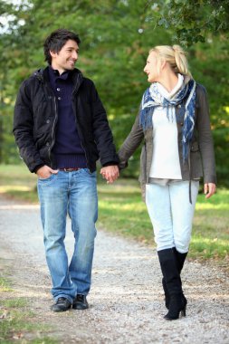 Couple taking a walk in the park clipart
