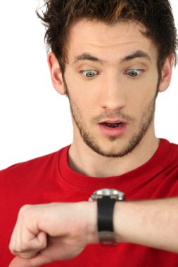 Man in shock looking at his watch clipart