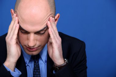 Businessman having a headache clipart