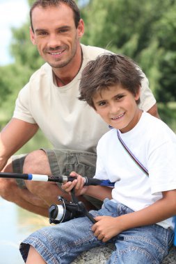 Father and son on a fishing trip clipart