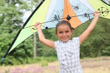 Girl flying her kite clipart