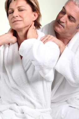 Husband giving wife neck massage clipart