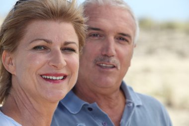 Mature couple at the beach clipart