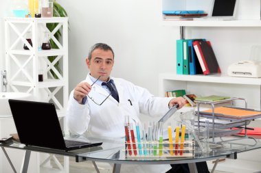 Important scientist in his office raising eyebrows clipart