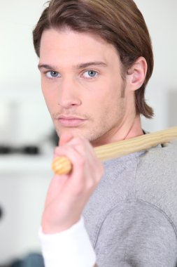 Handsome blue-eyed young man doing stretching exercises clipart