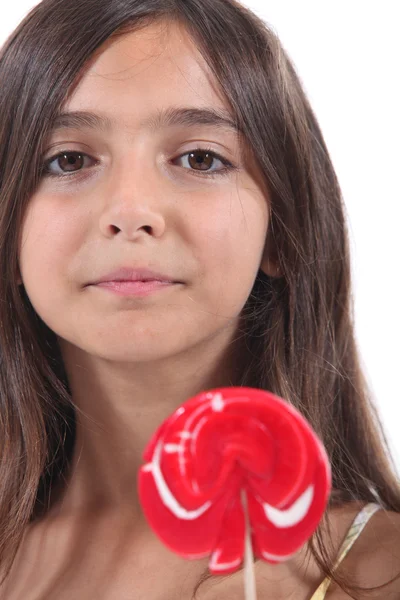 Little girl licking a lollipop — Stock Photo, Image