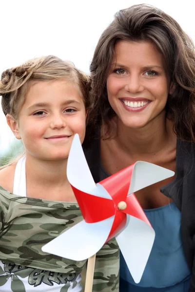 Mother and daughter with a windmill — Stock Photo, Image