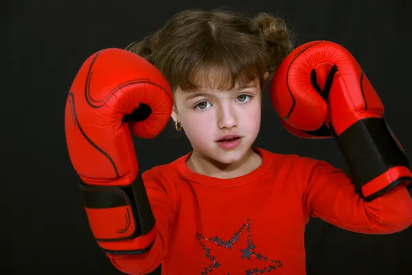Little girl wearing boxing gloves — Stock Photo, Image
