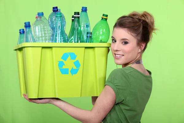 Woman recycling crate of plastic bottles — Stock Photo, Image
