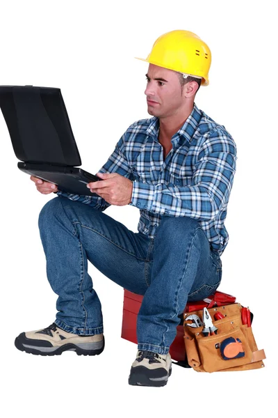 Distraught tradesman reading his emails — Stock Photo, Image