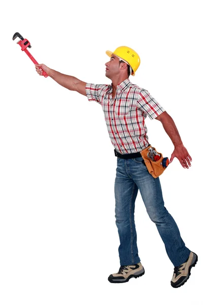 A handyman trying to reach something. — Stock Photo, Image