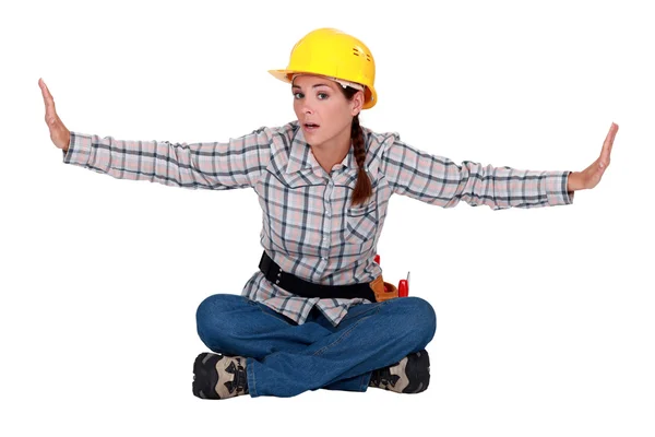 Constructora sentada con los brazos extendidos —  Fotos de Stock