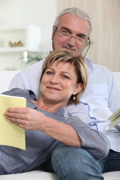 Mature couple relaxing on a couch — Stock Photo, Image