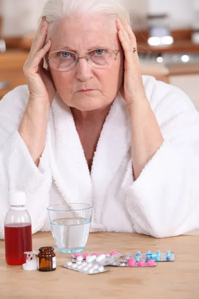 Bitter woman in front of her medication — Stock Photo, Image