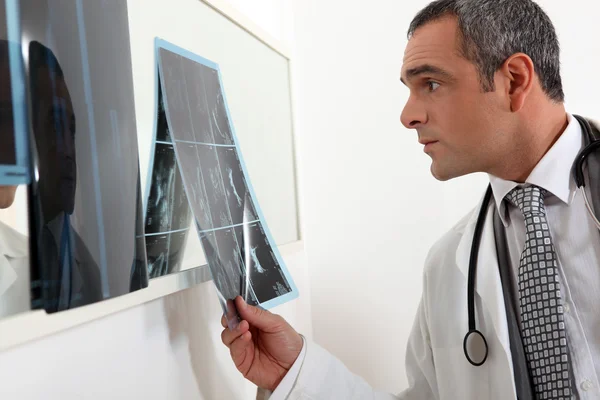 Médico examinando radiografias — Fotografia de Stock