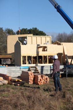 Craftsmen on a construction site clipart