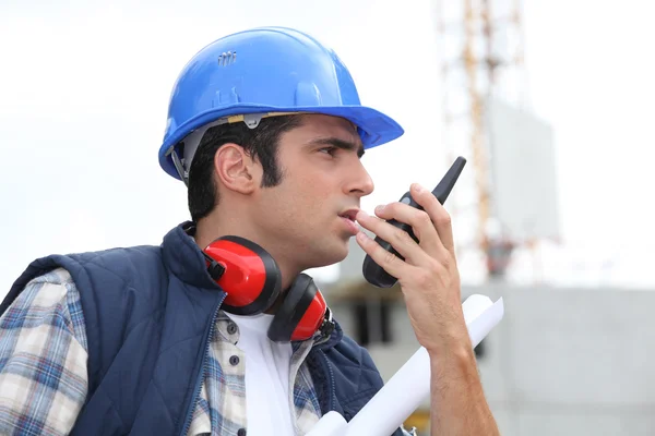 A foreman giving instructions through his cb. — Stock Photo, Image