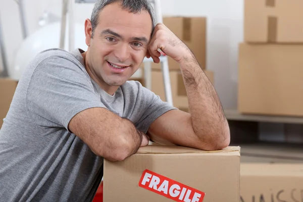 stock image Warehouse manager stood by boxes