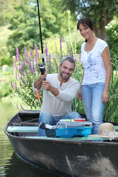 Couple in a fishing boat — Stock Photo, Image