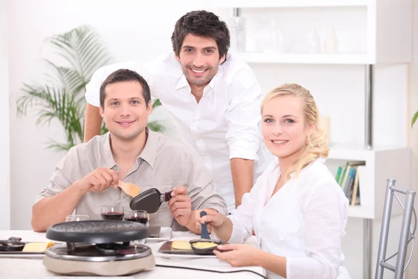 Friends eating raclette — Stock Photo, Image