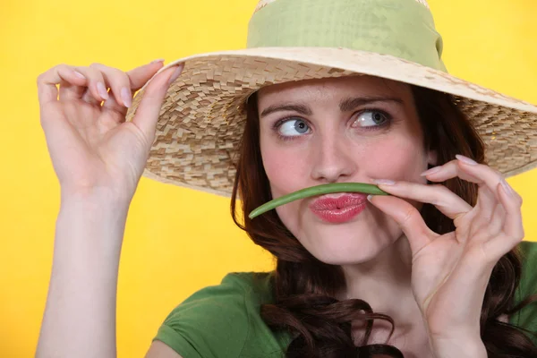 Woman using green bean as moustache — Stock Photo, Image
