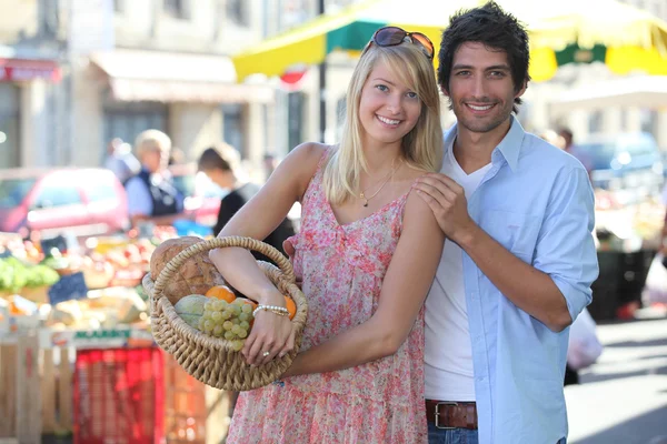 農産物のバスケットと市場でのカップル — ストック写真