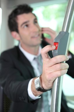 Businessman pressing button on bus clipart