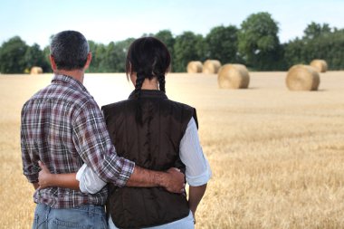 Couple looking at a field clipart