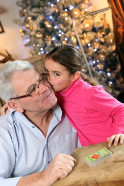 Grandfather and granddaughter at Christmas clipart