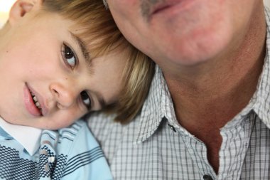 Young boy spending time with his grandfather clipart