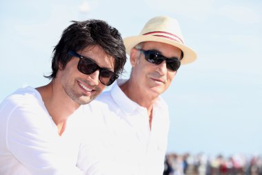 Two men in white tops and sunglasses clipart