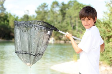 Young boy with a large fishing net clipart